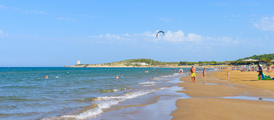 Vieste, Italy. View of the Scialmarino Beach with people on the beach and practicing water sports, on a Summer day, along the coast of Vieste. Banner header image. September 7, 2022