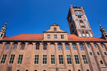 Fototapeta na wymiar The facade and towers of the historic Gothic town hall in Torun