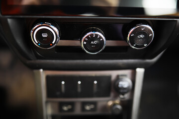 The process of choosing climate control in the car. Various controls in auto switches. Modern car interior