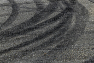 Tire track mark on asphalt tarmac road race track texture and background, Abstract background black tire tracks skid on asphalt road in racing circuit, Tire mark skid mark on asphalt road.