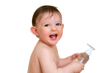 Happy baby toddler boy with a bottle of shampoo in a bathtub, isolated on white background. A smiling child at the age of one year