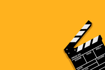 Fototapeta na wymiar Movie clapperboard for shooting videos and movies on a orange background plenty of space for text