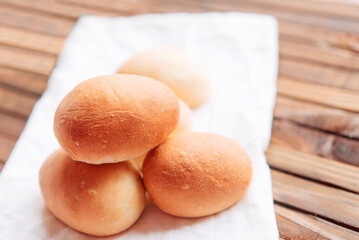 Fototapeta na wymiar Yeast buns for dinner. Fresh homemade buns on a white linen napkin. 