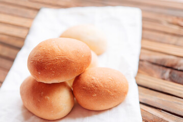 Yeast buns for dinner. Fresh homemade buns on a white linen napkin.	