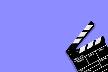 Movie clapperboard for shooting videos and movies on a lilac background plenty of space for text