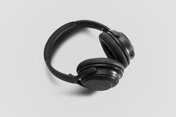 Computer headphones. Black headphones on a white background. The concept of listening to music, creating audio, music. Computer work, abstraction and minimalist style.