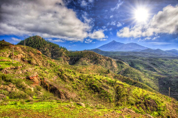 North-west coast of Tenerife mountains and green grass with blue sky with clouds, Canarian Islands