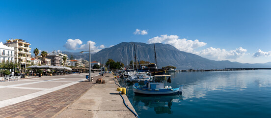 panorama view of the waterfront and harbor in Kalamata with many boats moored on the harbor wall