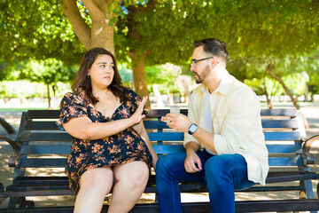 Caucasian man proposing marriage to his angry girlfriend