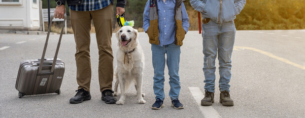 Family traveling with golden retriever dog. Father, children, pet and luggage getting out from hotel. Auto journey with kids and dog in car.