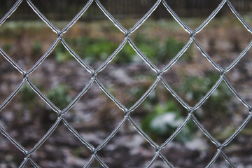 metal fence mesh covered with ice bad weather