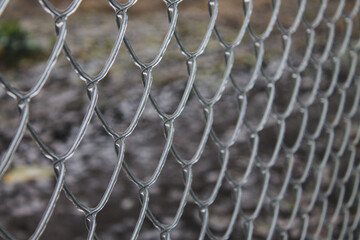 Fototapeta premium metal fence mesh covered with ice bad weather