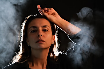 silhouette of a girl in the dark. smoke . steam . girl in a dark room.