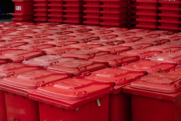 Storage infected bins for destruction in a waste disposal facility.Big red garbage jugs on the...
