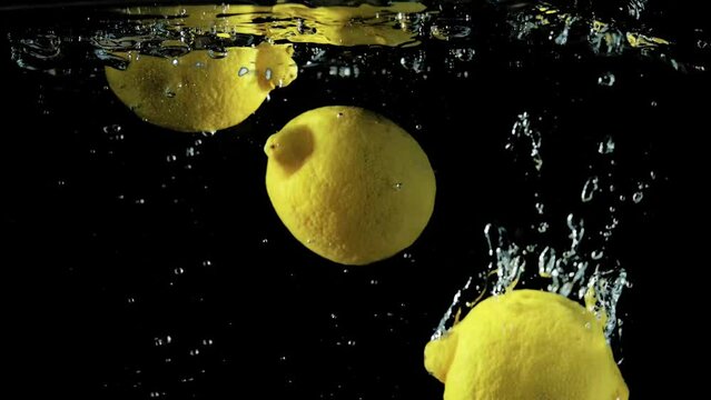 yellow lemons splash in water