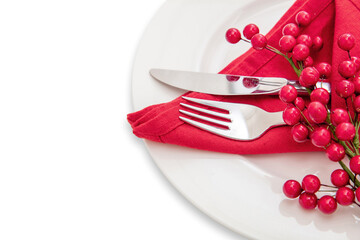 Holiday table setting. Silver Cutlery and red cloth napkin on white plate, close up