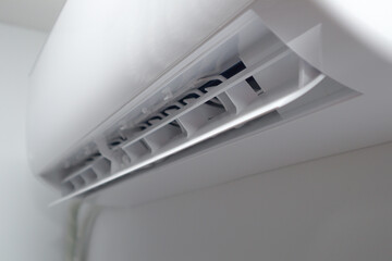 Air Conditioning Isolated on White Background. Modern Indoor Blocks of Split System Air Conditioner. Side View Close-up.