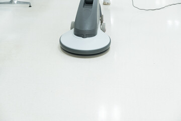 Naklejka premium Woman maid cleaning floor with machine cleaner in the business office.Big cleaning day.Floor care with machine in hospital.