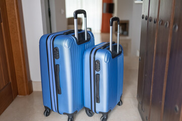 Couple of suitcases at the entrance of the holiday apartment to enjoy a few days of relaxation.