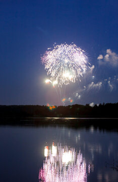 Colorful firework over blue water