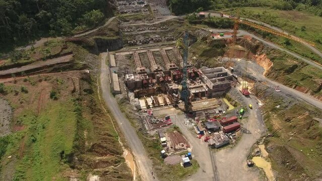 Aerial view. Flying over an industrial area in the rainforest. Construction of a hydroelectric power plant in the tropical jungle.  Equatorial Guinea, Africa.