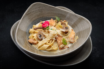 Pasta with mushrooms, salmon, cheese and meat