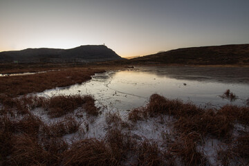 Sunset over the lake on the mountains
