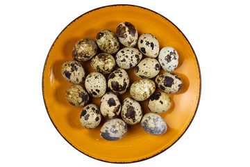 Fresh quail eggs on a round orange plate on white isolated, top view