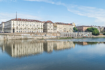 Fototapeta na wymiar The murazzi of Turin with the palaces that are reflected in the water of the river Po