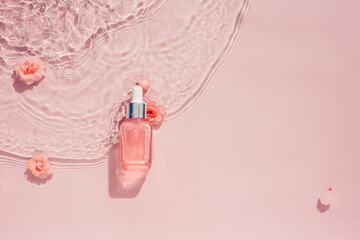 Cosmetic bottle with serum, rose oil, transparent water background with flowers