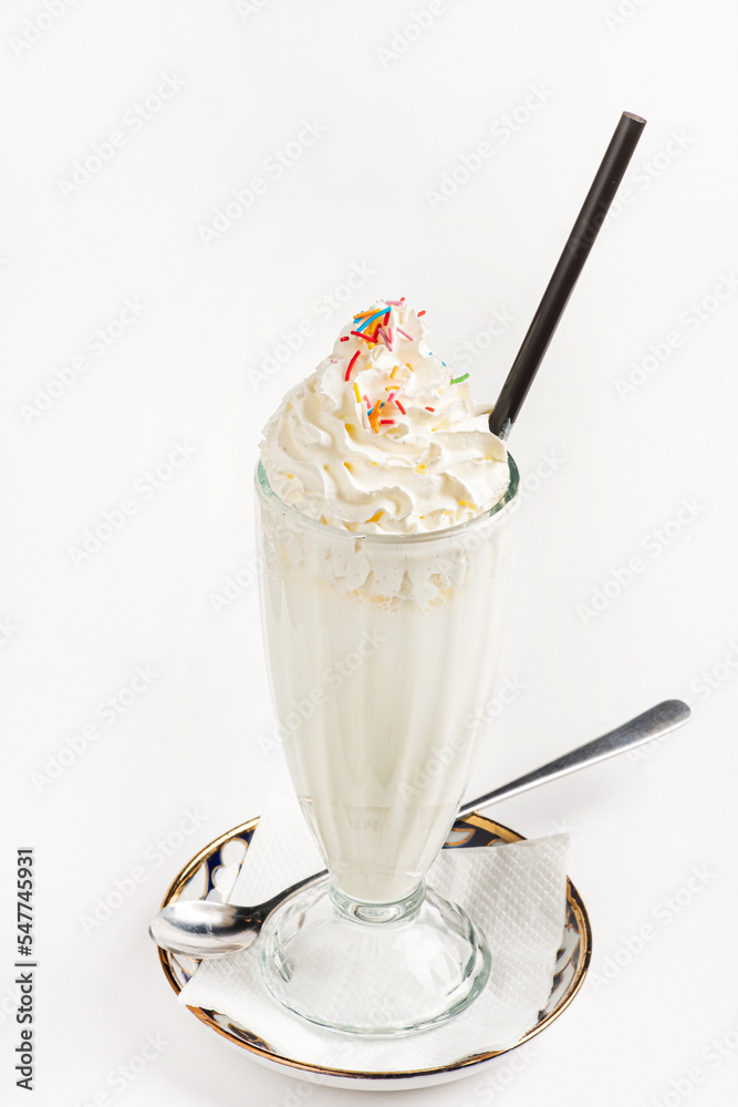 Wall mural milkshake with whipped cream on white background