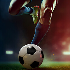 A closeup soccer player leg with a soccer ball in the field