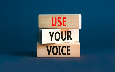 Use your voice symbol. Concept words Use your voice on wooden blocks on a beautiful grey table grey background. Business and use your voice concept. Copy space.
