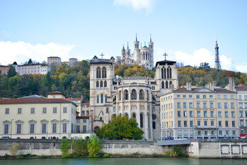 Autumn in Lyon with the Saône river and the saint jean cathedral in the foreground and behind our lady of fourviere basilica at the top of the hill.