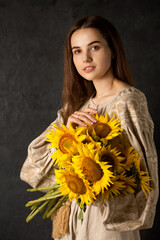 Ukrainian woman with a large bouquet of sunflowers