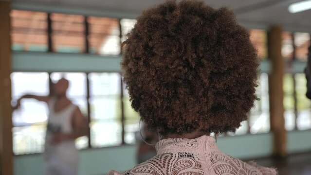 Woman with afro hair at Caribbean dance class