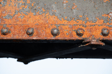 Rusty beam and bolts on old bridge