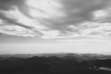 Fototapeta premium Dramatic black and white view of mountain range and cloudscape