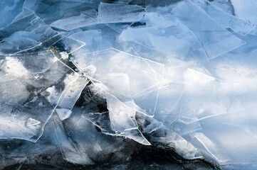 Shards of ice on frozen river surface in winter