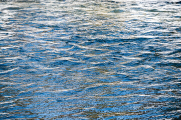 Waves and ripples on flowing river surface in winter