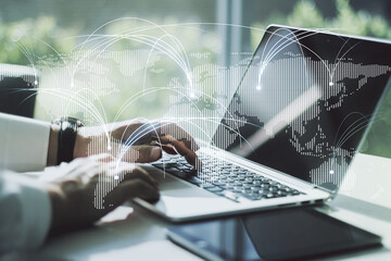 Double exposure of abstract digital world map with connections and hands typing on laptop on background, research and strategy concept