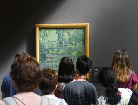 Paris, France - August 29, 2019: Crowd of visitors near the Water-Lily Pond, Symphony in Green 1899 by Claude Monet painting in Museum d'Orsay in Paris, France.