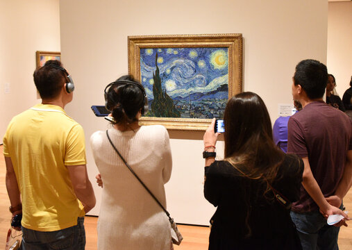 New York, USA - June 8, 2018: People near the Starry Night by Vincent van Gogh painting in Museum of Modern Art in New York City.