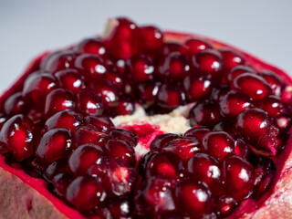 Ripe pomegranate. Fresh juicy pomegranate on a light background.