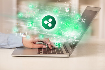 Young man watching stock market on laptop