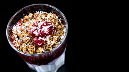 Smoothies. Fruit dissert with nuts and cherries in a glass cup. Milk and fruit smoothie with nuts and cherries.