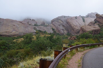 Rainy, misty day ad red rock conservation area with rusty metal roadside guardrails