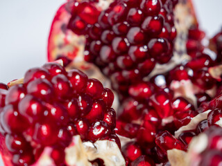 Ripe pomegranate. Fresh juicy pomegranate on a light background.