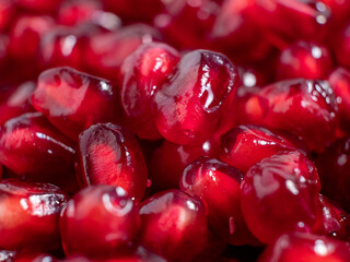 Ripe pomegranate. Fresh juicy pomegranate seeds on a light background.