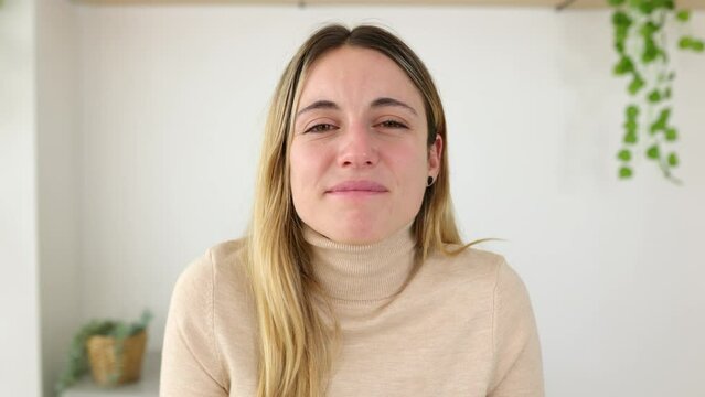 POV front view of young adult caucasian woman looking at laptop screen listening on video call.